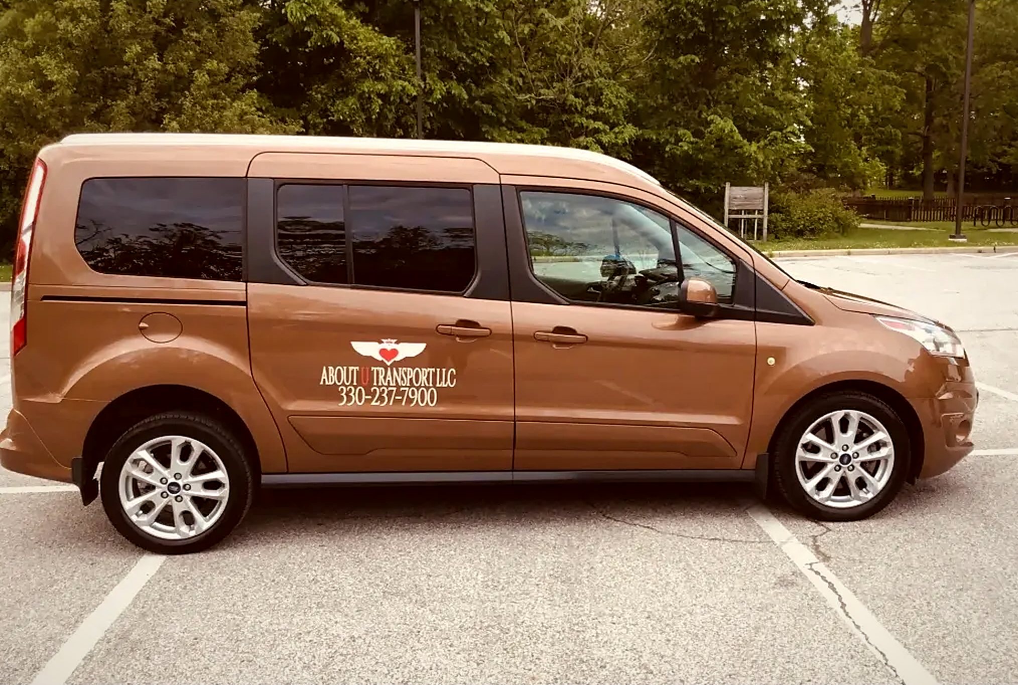 About U Transport van with the company emblem and phone number on the door